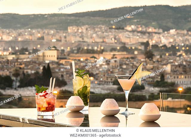Morocco, Fes, three cocktails at the roof terrace of a hotel by sunset