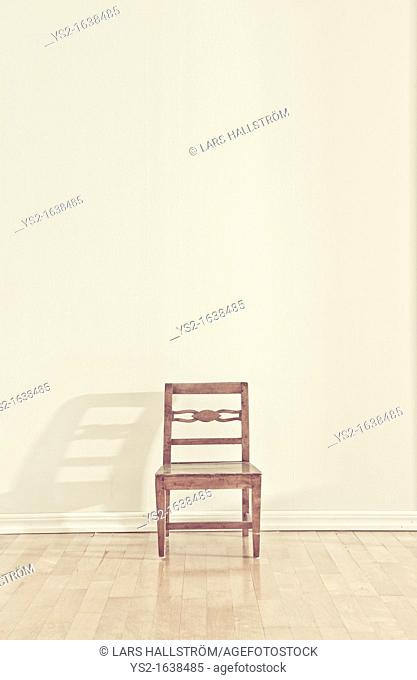 Empty chair in an empty room