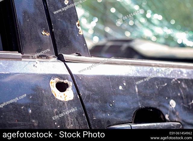Car riddled with bullets. War of Russia against Ukraine. A car of civilians shot by the Russian military during the evacuation of women and children