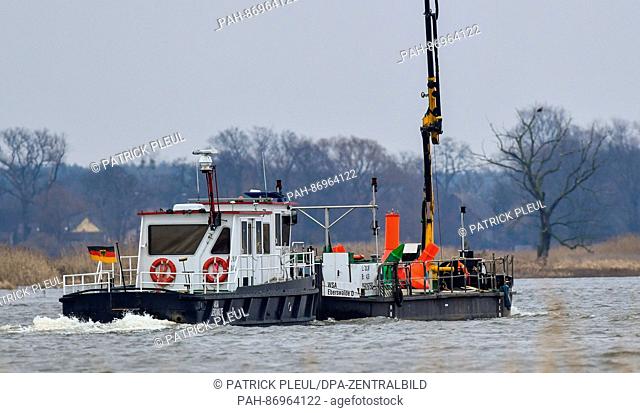 A working vessel of the water and shipping office in Eberswalde (WSA) is on the way upstream on the German-Polish border river 'Oder' near Genschmar, Germany