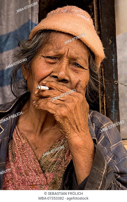 Old woman smoking cigarette, portrait