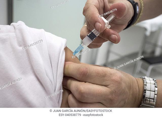 Nurse vaccinating little girl at Healthcare Center. Whooping cough, diphtheria and tetanus
