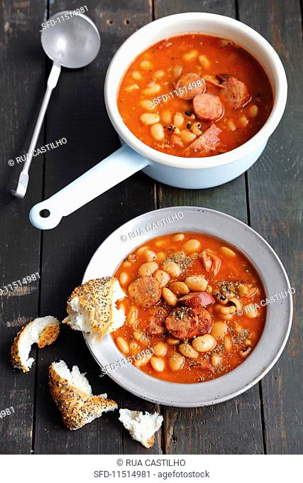 Stew with smoked pork belly, sausages, beans and tomatoes