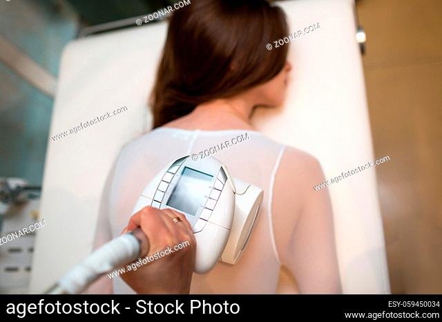 Young beautiful woman and LPG massage procedure in spa clinic. Lymphatic drainage massage LPG apparatus process