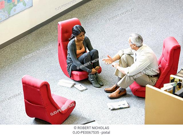 Business people having meeting in unconventional chairs