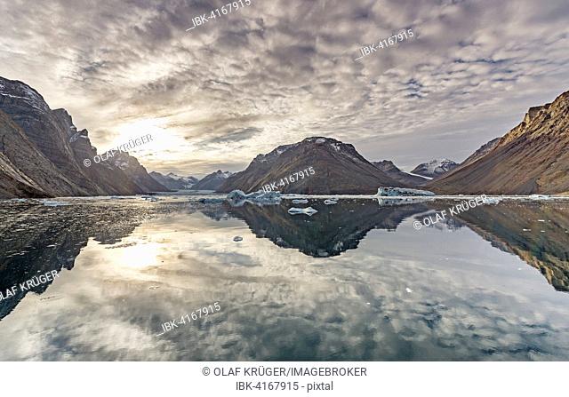 Reflection in the water, mountains and icebergs, Kaiser Franz Josef Fjord, Kejser Franz Josef Fjord, Northeast Greenland National Park, Greenland