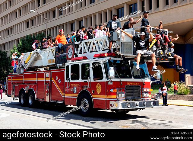 Indianapolis, Indiana, USA - September 28, 2019: The Circle City Classic Parade, Firetruck transporting people down Pennsylvania street during the parade