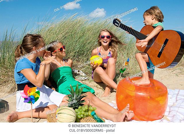 Child playing guitar for girls