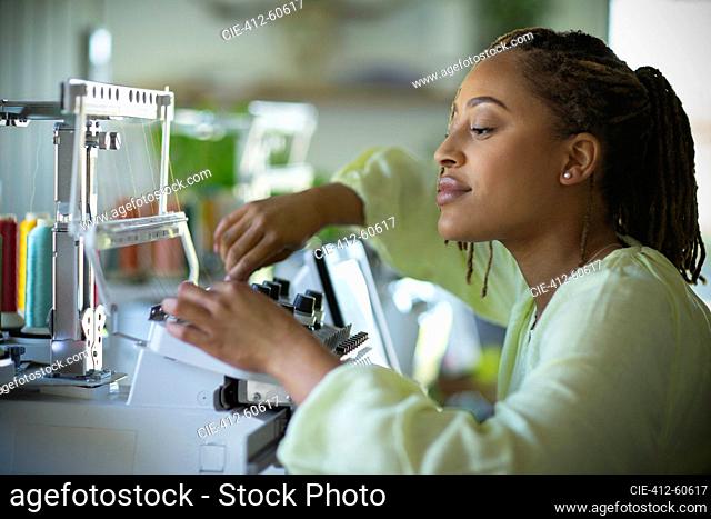 Young female seamstress at sewing machine