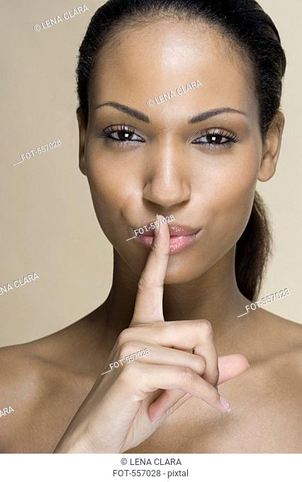 A woman putting her finger on her lips