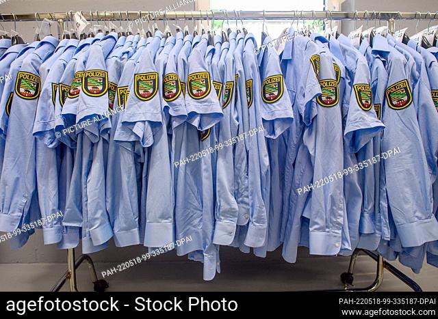 17 May 2022, Saxony-Anhalt, Magdeburg: Shirts of the police of Saxony-Anhalt hang in the Clothing Service Center (BSC) of the Police Inspectorate Central...