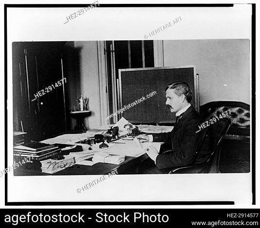 Dr. Miller, Treasury Department employee, half-length portrait, seated at.., between 1884 and 1930. Creator: Frances Benjamin Johnston