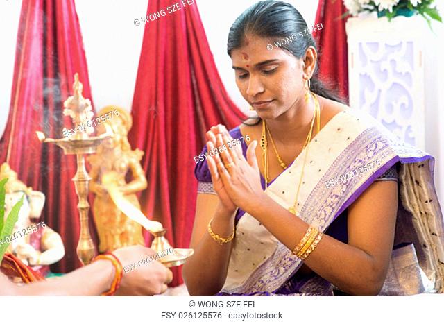 Woman received prayers from priest. Traditional Indian Hindus ear piercing ceremony. India special rituals