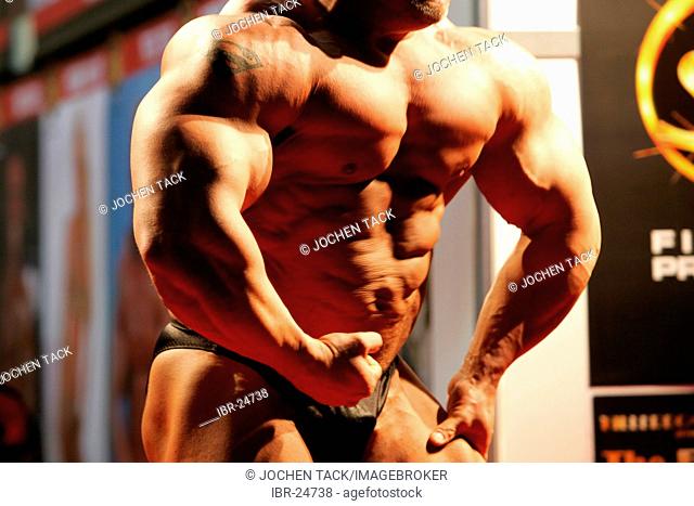 DEU, Germany, Essen : FIBO, Fitness and leisure exhibition. Muscle show of a bodybuilder