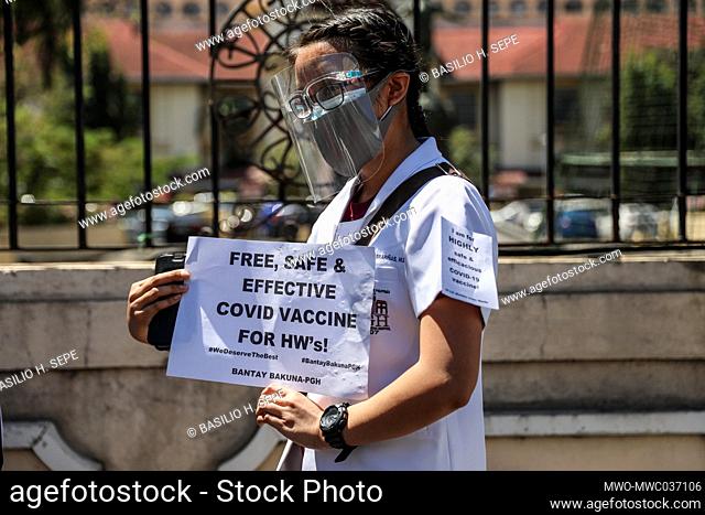 Healthcare workers call for a free, safer and effective COVID-19 vaccine during a protest outside the Philippine General Hospital in Manila