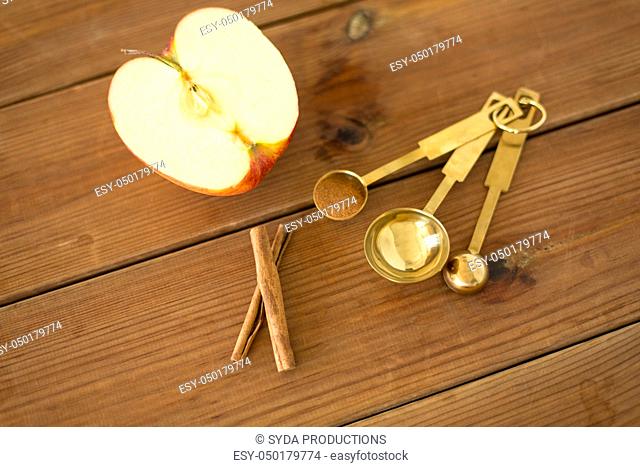 half apple and knife on wooden cutting board