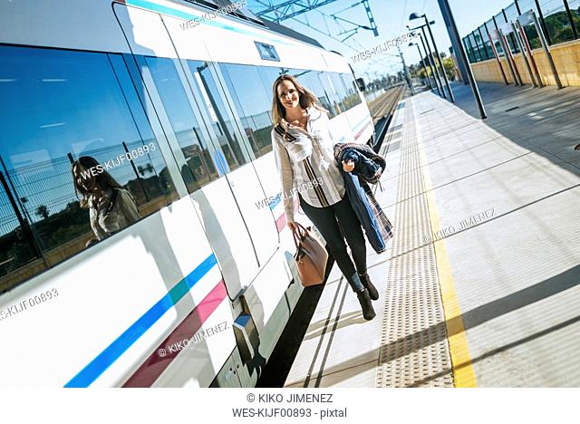 Woman walking on platform next to train
