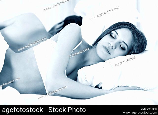 Portrait of couple sleeping in the bed at home