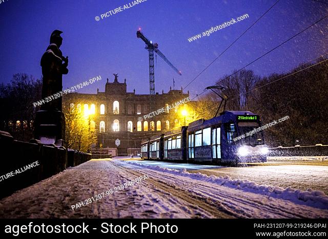 01 December 2023, Bavaria, Munich: Thick snowflakes fall from the sky in front of the Maximilianeum, seat of the Bavarian State Parliament