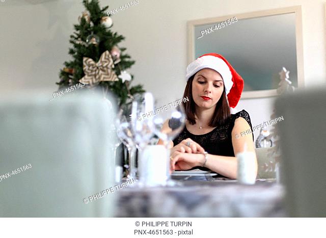 Brunette woman alone at a Christmas Eve table