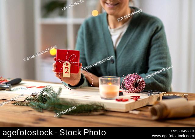 close up of woman showing christmas gift at home