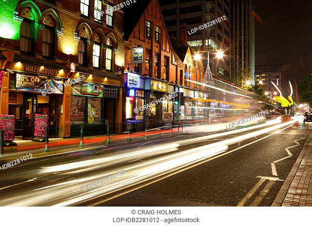 England, West Midlands, Birmingham. Light trails from cars travelling along Broad Street at night