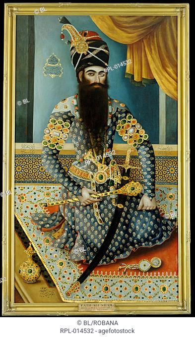 Fath 'Ali Shah, King of Persia 1797-1834. The Shah is shown sitting on a rich carpet, wearing a tight fitting blue costume thickly adorned with jewels