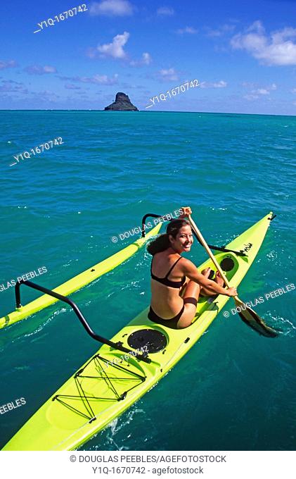 Polynesian woman in outrigger canoe, Kaneohe Bay, Oahu, Hawaii, USA