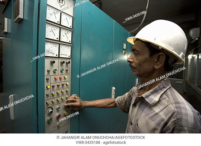 A Steel Mill factory operator using machine at Demra, Dhaka, Bangladesh