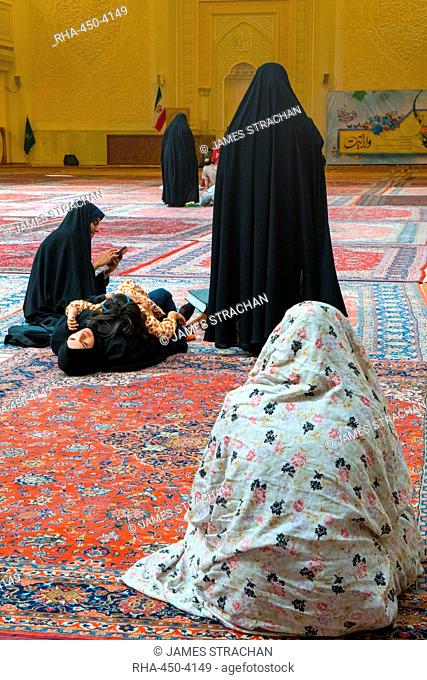Women and child gathered, interior, Aramgah-e Shah-e Cheragh (Mausoleum of the King of Light), Shiraz, Iran, Middle East
