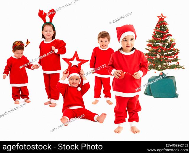 Happy little children preparing for Christmas wearing Santa costume