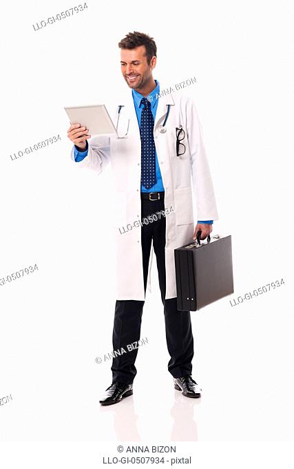 Smiling doctor checking something on digital tablet Debica, Poland