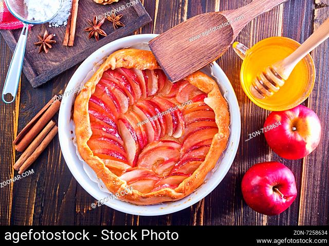 apple pie with honey and cinnamon on a table