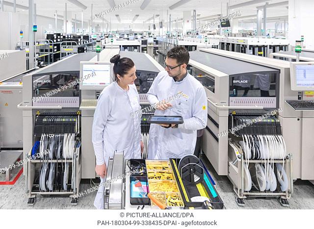 02 March 2018, Germany, Ingolstadt: Workers checking the production of singular components for assembly of circuit boards for radar sensors at Continental...