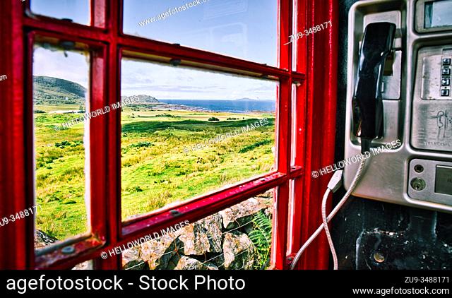 View of the Atlantic Ocean from inside remote traditional red telephone box, Ardnamurchan Peninsula, Lochaber, Highland, Scotland