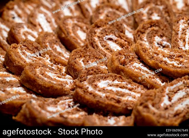 Christmas yule log, buckwheat dough and cream filling, selective focus, close up, food and dessert concept, traditional sweets