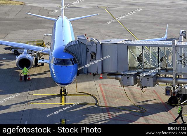 Aircraft KLM Cityhopper, Embraer ERJ-190, PH-EXE, docked passenger boarding bridge
