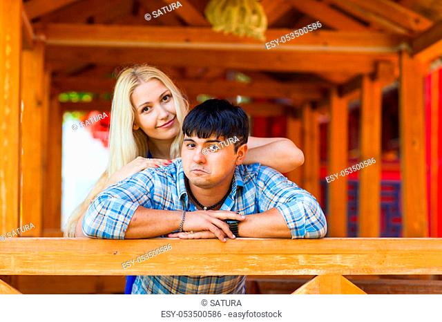 Happy loving couple. Portrait of beautiful young couple bonding to each other and smiling while both standing outdoors