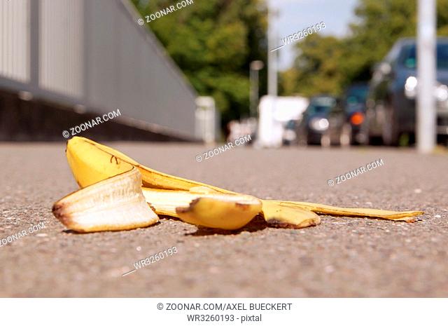 discarded banana skin lying on pavement with selective focus