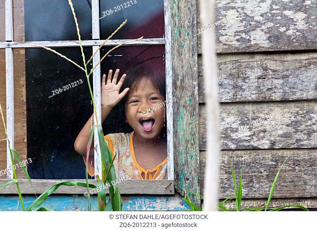 Little Girl behind a Window Glass in Banjarmasin, Indonesia
