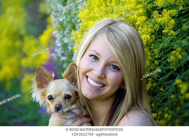 A young woman outdoors with her chihuahua