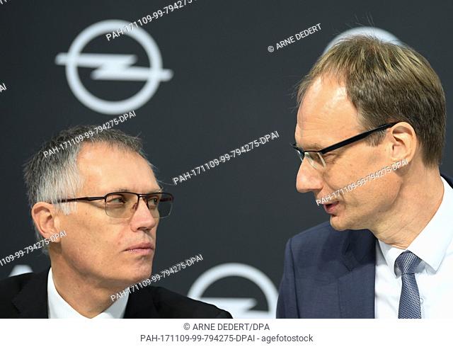 Opel's CEO Michael Lohscheller (R) and PSA's chairman Carlos Tavares have a talk during the start of the press conference at the Opel Design Centre in...