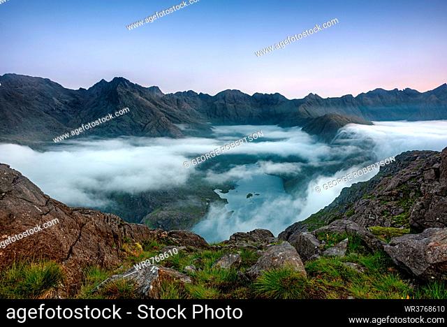 Early morning clouds drifting over the hills flowing down to Loch Coruisk below with the Cuillin Ridge in the background, Isle of Skye, Inner Hebrides, Scotland