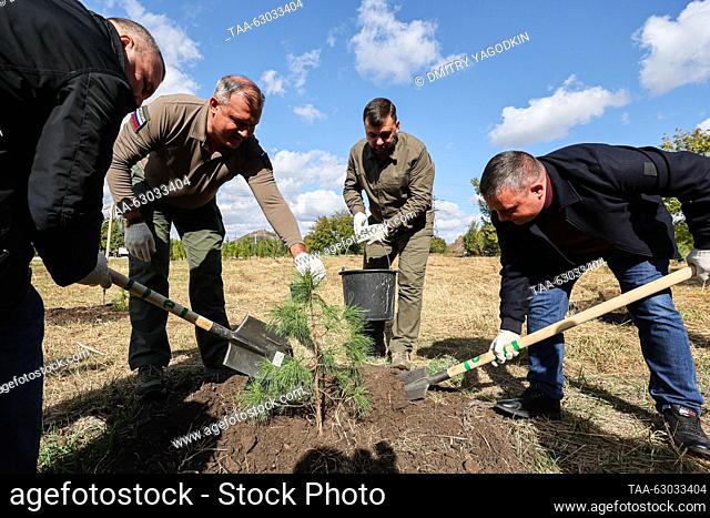 RUSSIA, DONETSK - OCTOBER 5, 2023: Donetsk Mayor Alexei Kulemzin and Donetsk People's Republic Head Denis Pushilin (L-R centre) plant cedars in Alexander...