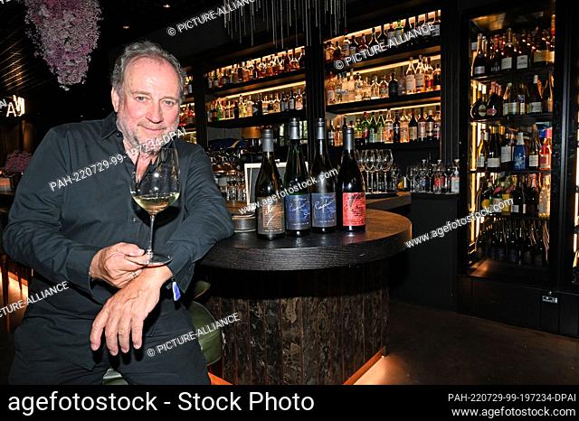 28 July 2022, Bavaria, Munich: Host, musician and Wine Gourmet of the Year 2018, Harold Faltermeyer, presents his wines before the wine tasting at the WACA...