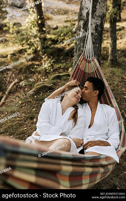 Couple relaxing in hammock