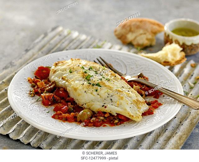 Cod fillets on tomato and olive salsa