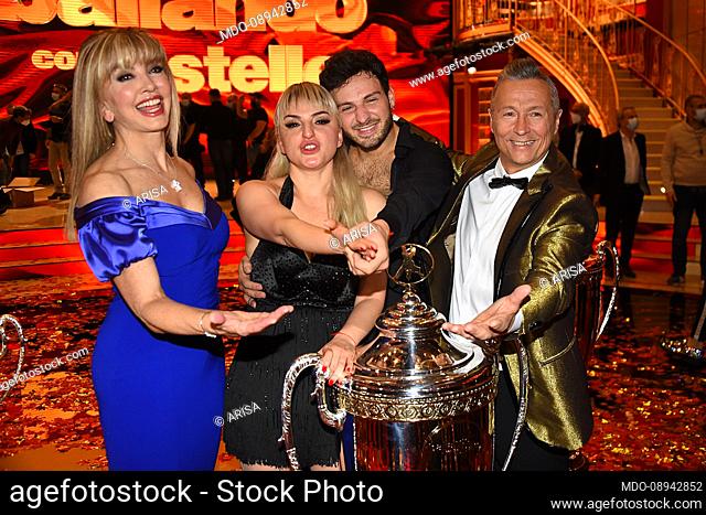 The host Milly Carlucci with the co-host Paolo Belli and the winners Arisa and Vito Coppola during the final of the broadcast Dancing With The Stars