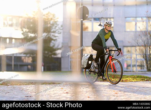 Middle-aged man on road bike, commuter, urban, Munich, Germany