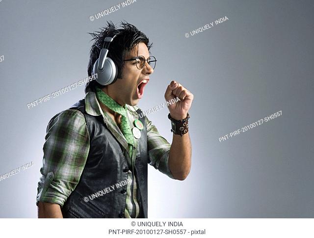 Man listening to headphones and singing
